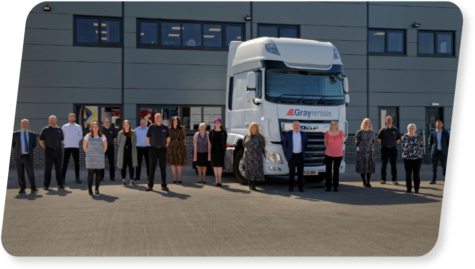 grayrentals team standing in front of the building